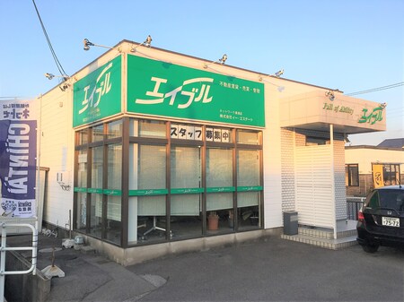 白の外観で大きな窓がありますので明るいお店です。駐車場もありますので、お車でもお気軽にご来店下さい。